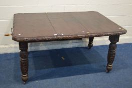 AN EARLY 20TH CENTURY CARVED OAK WIND OUT DINING TABLE, with one additional leaf on turned legs with