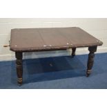 AN EARLY 20TH CENTURY CARVED OAK WIND OUT DINING TABLE, with one additional leaf on turned legs with