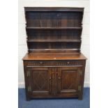 A 20TH CENTURY OAK DRESSER, with two drawers and double panelled doors, width 122cm x depth 45cm x