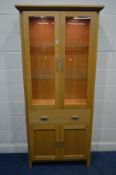 A MORRIS FURNITURE COMPANY, RANGE HORIZON, LIGHT OAK GLAZED TWO DOOR BOOKCASE, two glass shelves,