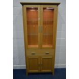 A MORRIS FURNITURE COMPANY, RANGE HORIZON, LIGHT OAK GLAZED TWO DOOR BOOKCASE, two glass shelves,