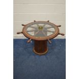 A LARGE STAINED WOOD AND BRASS BOUND SHIPS WHEEL COFFEE TABLE, on a cylindrical pillar, diameter