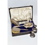 A CASED SILVER VANITY SET WITH TWO CANDLE STICKS AND A TEASPOON, the brown case opens to reveal a