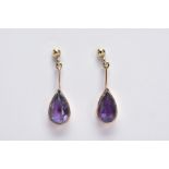 A PAIR OF 9CT GOLD AMETHYST DROP EARRINGS, each designed with a pear cut amethyst within a collet