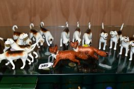 BESWICK FOXES AND FOXHOUNDS, comprising two foxes No 1440 (leg reglued on one), two foxhounds No 941