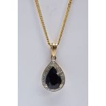 A 9CT GOLD SAPPHIRE AND DIAMOND PENDANT NECKLET, the pendant of a tear-drop shape, set with a pear