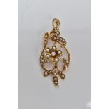 A YELLOW METAL SEED PEARL PENDANT, of an openwork design, featuring a central flower set with a seed