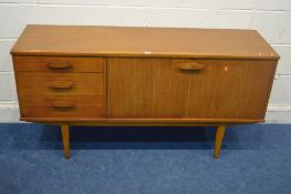 A MID TO LATE 20TH CENTURY TEAK SIDEBOARD, two cupboard doors, flanked by three drawers, width 144cm