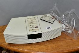 A BOSE WAVE RADIO, model number AWR132 with remote control and power cable