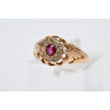 A LATE VICTORIAN 18CT GOLD RUBY AND DIAMOND CLUSTER RING, designed with a central, circular cut ruby