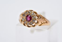 A LATE VICTORIAN 18CT GOLD RUBY AND DIAMOND CLUSTER RING, designed with a central, circular cut ruby