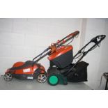 A FLYMO CHEVRON 34VC ELECTRIC LAWN MOWER and a Gardenline Electric Scarifier, both with grass