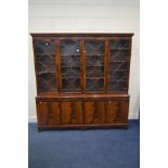 A MAHOGANY ASTRAGAL GLAZED FOUR DOOR BOOKCASE, above four cupboard door base, width 183cm x depth