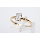 A MODERN SINGLE STONE DIAMOND RING, designed with a claw set emerald cut diamond, total estimated