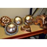 THREE VINTAGE CIRCULAR COPPER STRAINERS, each fitted with a hanging loop and worn plating,