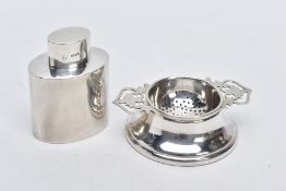 A SILVER TEA STRAINER AND TEA CADDY, the tea strainer with double openwork handles hallmarked