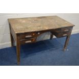 A DISTRESSED 1940'S OAK DESK, with four drawers, width 133cm x depth 73cm x height 77cm