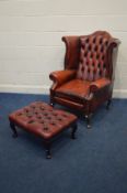 AN OXBLOOD BUTTONBACK ARMCHAIR, 83cm x depth 86cm x height 88cm (one tear to left arm) and a