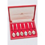 A CASED SET OF SIX SILVER ENAMELLED COFFEE SPOONS, each silver gilt spoon has a decorative floral