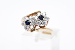 A 9CT GOLD SAPPHIRE AND CUBIC ZIRCONIA DOUBLE CLUSTER RING, designed with two asymmetrical clusters,