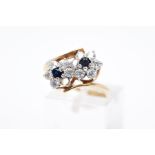 A 9CT GOLD SAPPHIRE AND CUBIC ZIRCONIA DOUBLE CLUSTER RING, designed with two asymmetrical clusters,