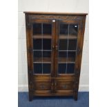 A JAYCEE OAK LEAD GLAZED TWO DOOR BOOKCASE, above double cupboard doors, width 91cm x depth 30cm x