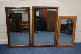 A MODERN OAK FINISH WALL MIRROR, 117cm x 70cm, along with a pine framed wall mirror and another