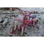 TWO PINK CHILDS BIKES, one with stabilisers