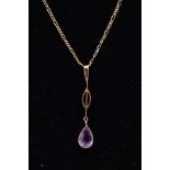 A YELLOW METAL AMETHYST PENDANT NECKLACE, the drop pendant set with a pear cut amethyst within a