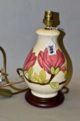 A MOORCROFT 'PINK MAGNOLIA' baluster shaped lamp base fitted to a wooden base, metal bayonet light