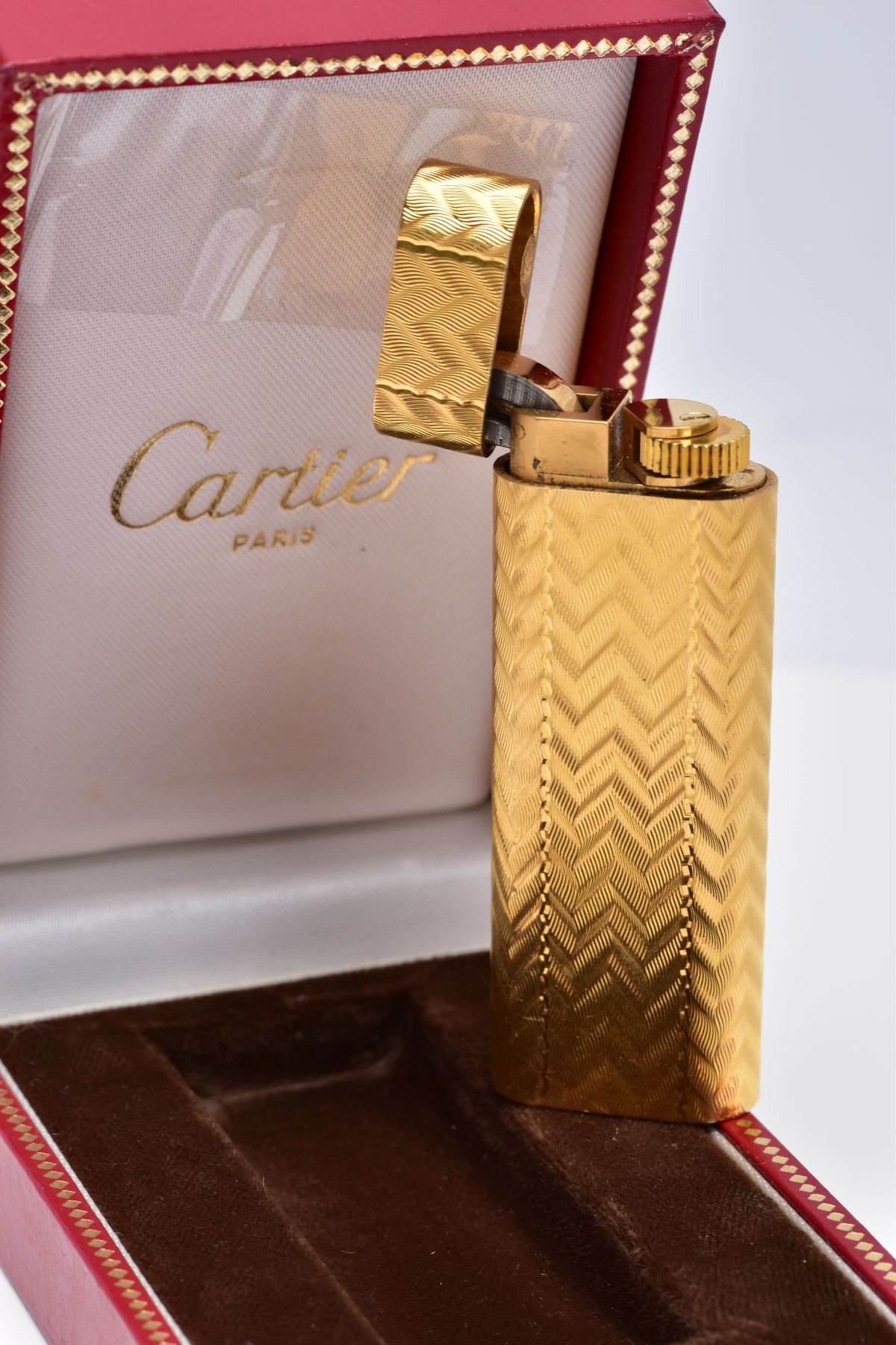 A CARTIER GOLD PLATED LIGHTER, oval rectangular form with engine turned engraving decoration, signed - Image 2 of 4