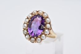 A 9CT GOLD AMETHYST AND PEARL CLUSTER RING, designed with a central oval mix cut amethysts, within a