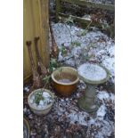 A COMPOSITE BIRD BATH on a separate base, along with two glazed garden plants, one with contents,