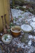 A COMPOSITE BIRD BATH on a separate base, along with two glazed garden plants, one with contents,