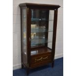 A REPRODUCTION LOUIS STYLE MAHOGANY SINGLE DOOR DISPLAY CABINET, with brass mounts, mirrored back,