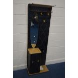 A 1950'S BLACK FINISH HALL STAND, with a brassed coat stand, oval mirror above a single cupboard