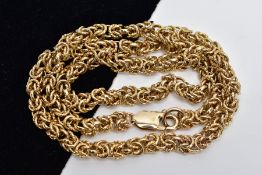 A YELLOW METAL HEAVY CHAIN, byzantine chain designed with plain and textured multi joined circular