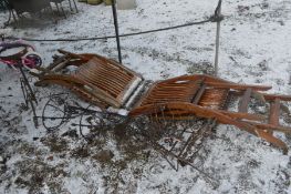 FOUR WIRE GARDEN ITEMS, to include wheelbarrow shaped plant basket, a pair of wall mounted plant