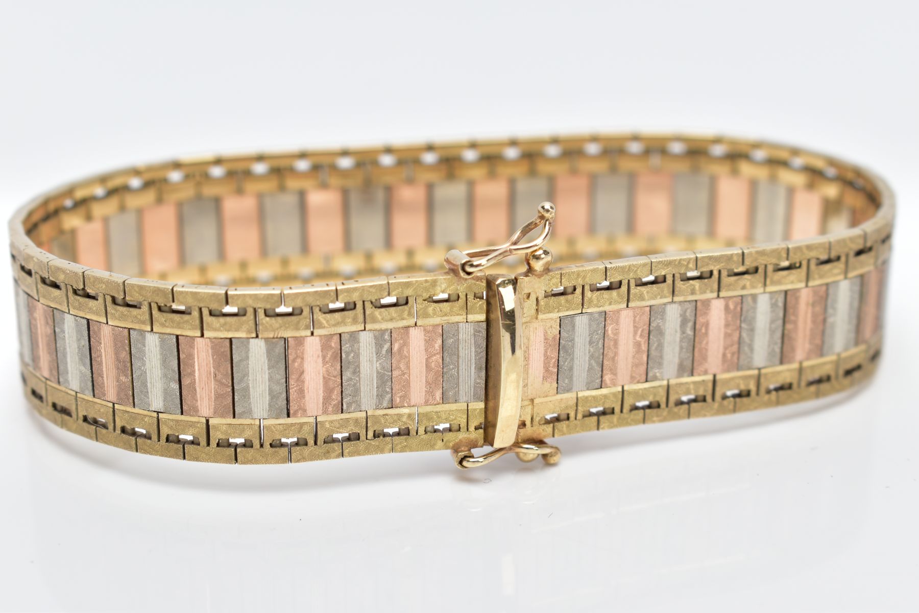 A 9CT TRI-COLOURED GOLD WIDE FLAT LINK BRACELET, designed with textured yellow, rose and white - Image 5 of 5
