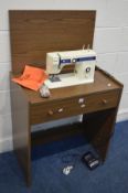 A NEWHOME MODEL 109/110 SEWING MACHINE in a teak finish case (PAT pass and working)