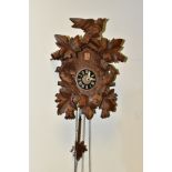 A MID 20TH CENTURY WOODEN CASED CUCKOO CLOCK, carved with three birds and an arrangement of leaves