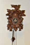 A MID 20TH CENTURY WOODEN CASED CUCKOO CLOCK, carved with three birds and an arrangement of leaves