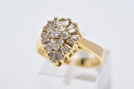 A YELLOW METAL DIAMOND CLUSTER RING, the raised cluster of a pear shape designed with a round