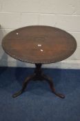 A GEORGIAN CARVED OAK CIRCULAR TOPPED TRIPOD TABLE, with a carved mythical creature to the top,