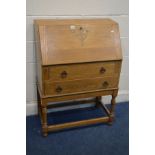 A EARLY TO MID 20TH GOLDEN OAK BUREAU, above two exterior drawers, width 74cm x depth 39cm x