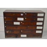 A SMALL EARLY TO MID 20TH CENTURY STAINED MAHOGANY OFFICE BANK OF TWELVE ASSORTED DRAWERS, oak lined