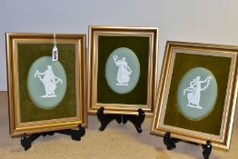 THREE GILT FRAMED AND VELVET MOUNTED WEDGWOOD GREEN JASPERWARE OVAL PLAQUES, each depicting a