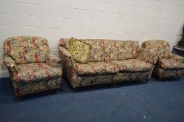 A NATURE AND FLORAL UPHOLSTERED THREE PIECE LOUNGE SUITE, on mahogany legs with brass caps and