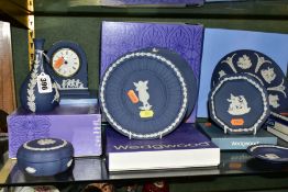 A GROUP OF BOXED AND LOOSE PORTLAND BLUE WEDGWOOD JASPERWARE, including four trinket boxes, a bud