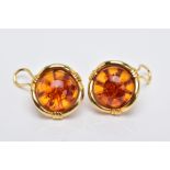 A PAIR OF YELLOW METAL, AMBER CABOCHON EARRINGS, each designed with a circular cabochon amber within